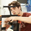 A man working with a 3D printer